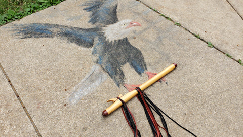 Eagle made from chalk carrying a native american flute
