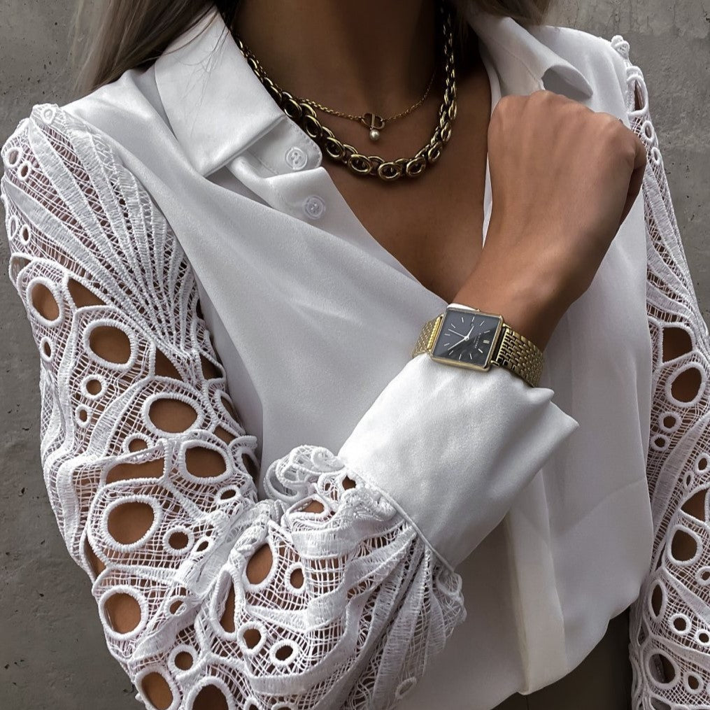 Product image showing elegant black blouse with lace sleeves
