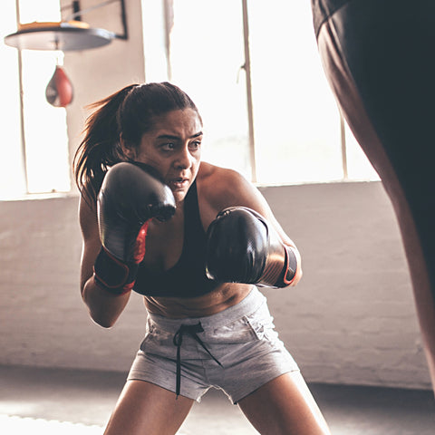 woman boxing punching a bag lady training boxing