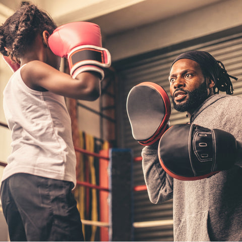 boxing kids training boxing on focus pads with coach