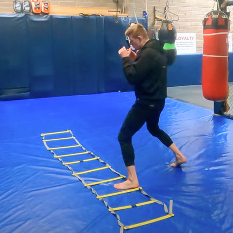 boxer doing agility ladder work in the gym for boxing