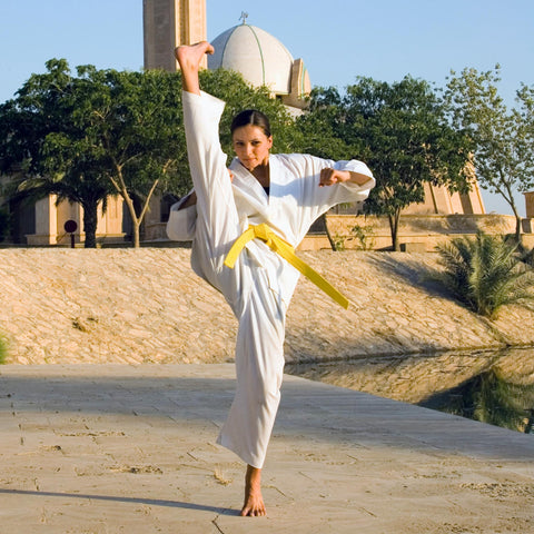 woman front kick high in gee for karate high kick