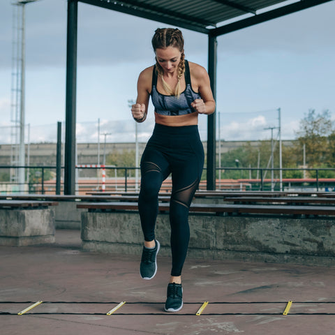 fit woman doing agility ladder work