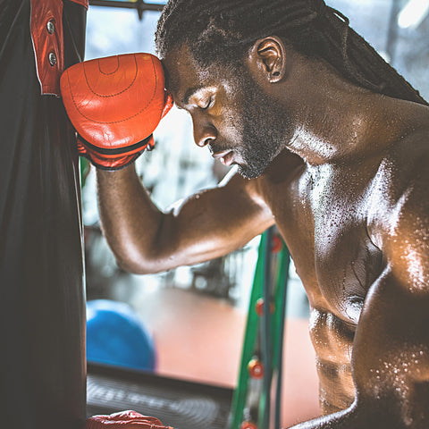 man boxing tired after workout sweating boxing