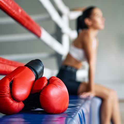 boxing gloves on a boxing ring after woman trains boxing