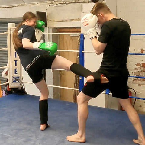 man and woman sparring kickboxing and having fun sparring in valour strike boxing gloves