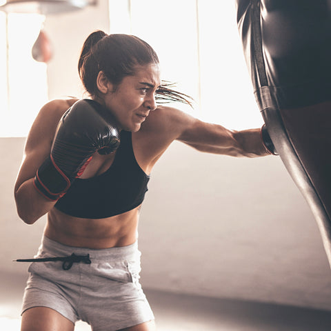 woman boxing fit woman boxing on punch bag mma kickboxing