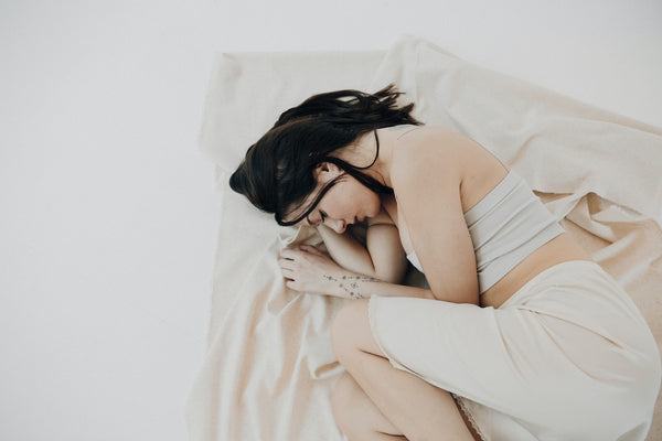 woman-sleeping-curled-up