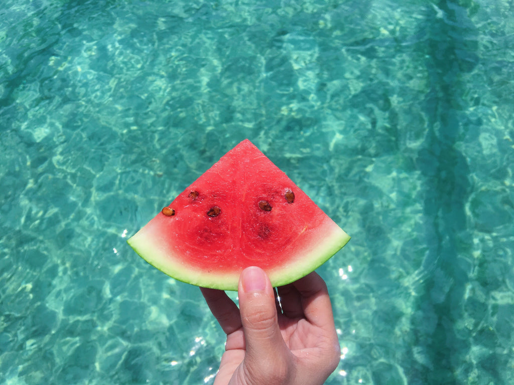 watermelon-held-over-pool