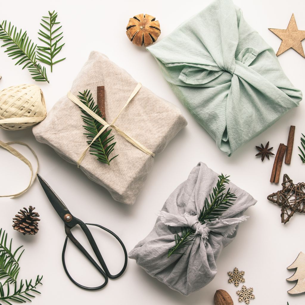 Hero image featuring a top down view of sustainable gift wrapping and holiday decor