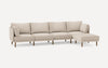 Beige sectional sofa with wooden legs, consisting of four seats and an extended chaise lounge on the right side.