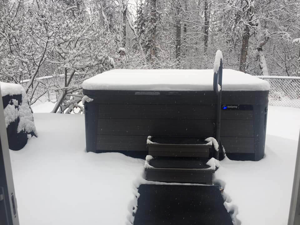 Short HeatTrak mat walkway leading to hot tub, surrounded by now