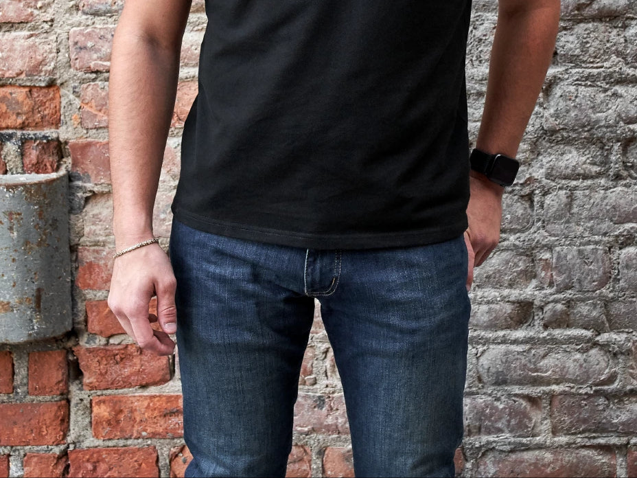 Ash & Erie Black Polo An up-close image of a young man with his hands to his side while wearing an Ash & Erie black polo.