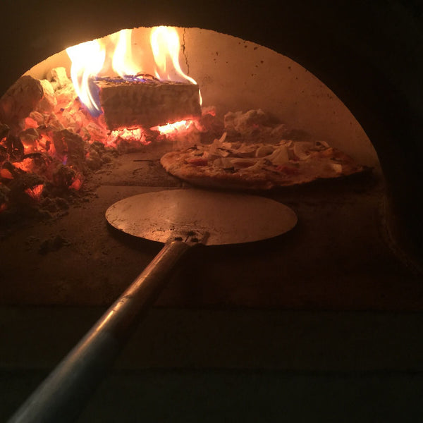 Cook pizza in wood fired oven