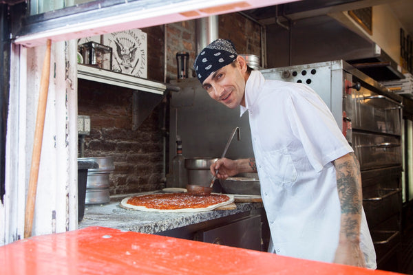 man making pizza dough base