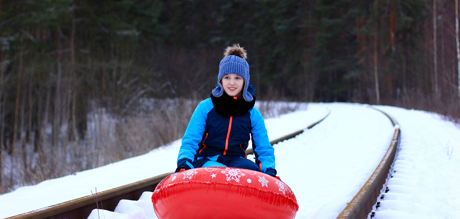 kid with a snow tube