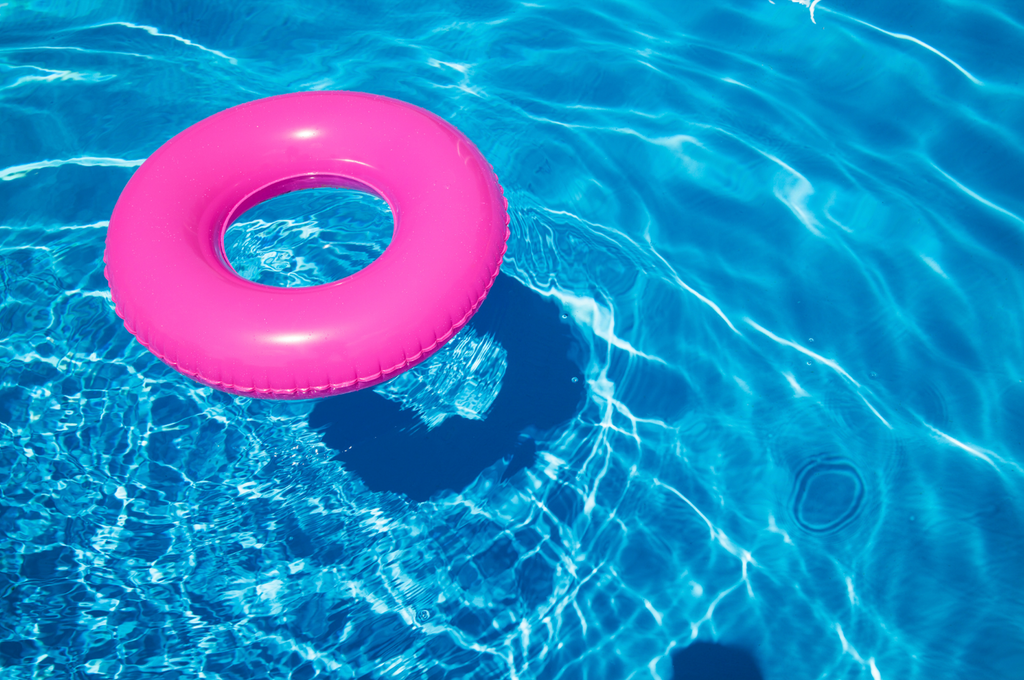 Premium Photo | Blue aqua background pool float rainbow ring floating in a  refreshing blue swimming pool inflatable