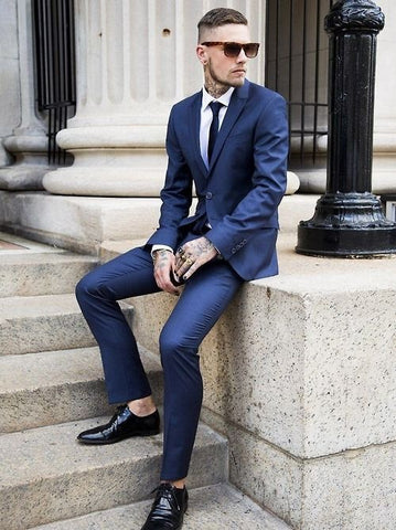 A navy suit gives a royal look, and when you match it with black shoes, it sharpens the elegance