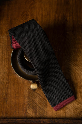 A solid-colour tie is always a safe choice with black suits