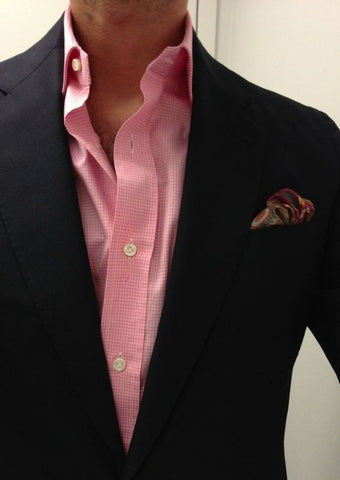 pairing a black suit with a pink shirt is a bold and stylish choice that can elevate your look to new heights