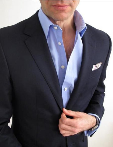 A blue shirt is an incredibly versatile option that complements a black suit exceptionally well