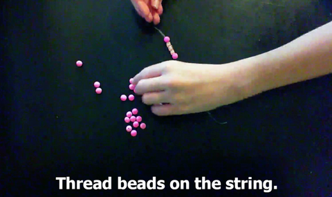 Thread beads on the string. 