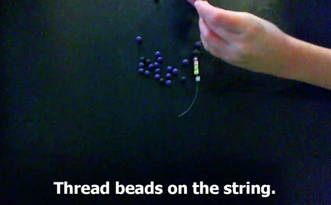 Thread different beads on the string. 