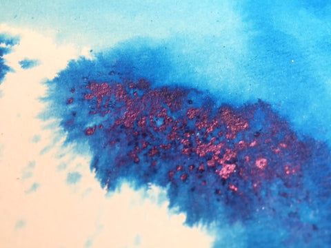 Blue ink splash with red on white background
