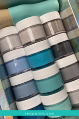 A stack of different SeaPaint paint colors and shades