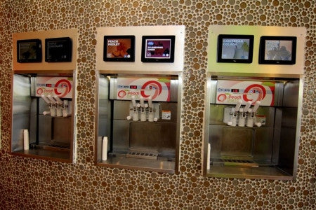 3 wall mounted frozen yogurt machines in froyo shop