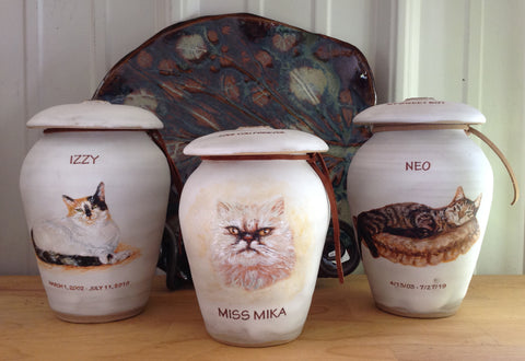 Three handpainted cat cremation urns