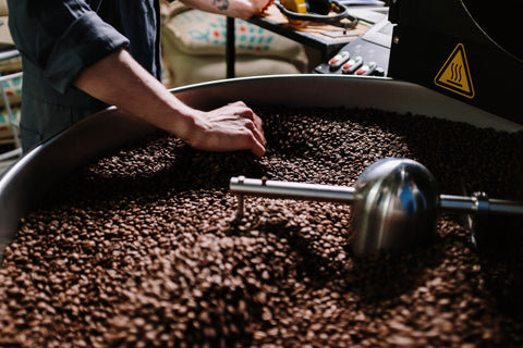 coffee being roasted in a drum roaster