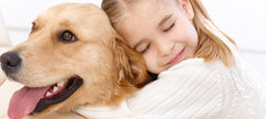 Little girl hugging dog