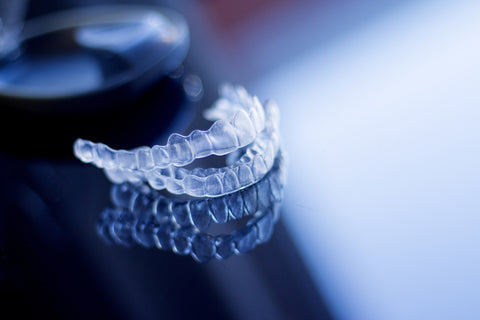 An image showing Invisalign attachments, used in clear aligner treatment for straight teeth.