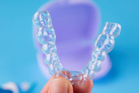 Image of someone cleaning their clear aligners.