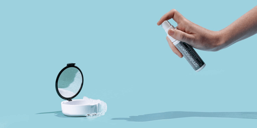 Demonstrating how to clean Invisalign using Smilesaver cleaning spray
