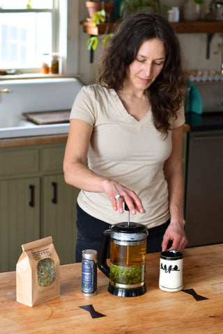 Herbal Revolution founder Kathi brewing Goodnight Moon Tea in a French press in her kitchen