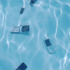 flip phones at the bottom of a pool