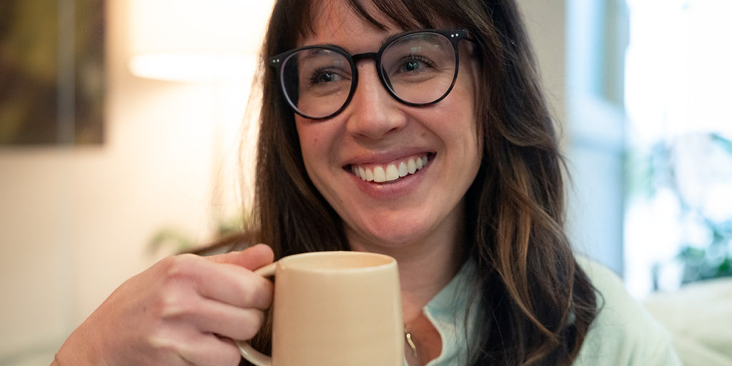 woman drinking chai from a mug