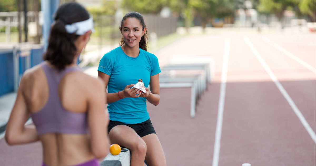 Two friends enjoy hemp protein bars after workout