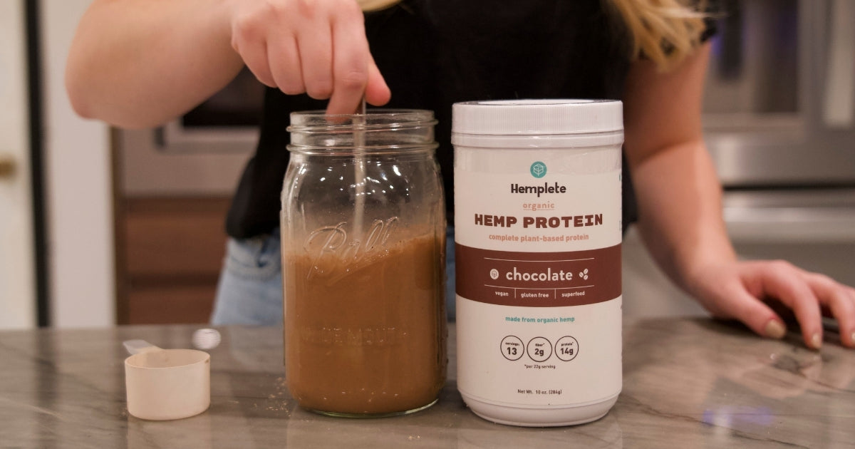 woman preparing chocolate hemp protein shake