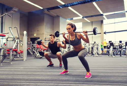 Woman & man lifting weights