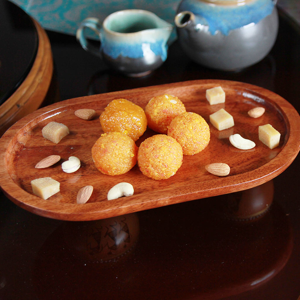 Wooden Oval Tray With Lord Ganesha's Favourite Modak. Shop Personalized Wooden Gifts For Ganesh Chaturthi From The Woodgeek Store.