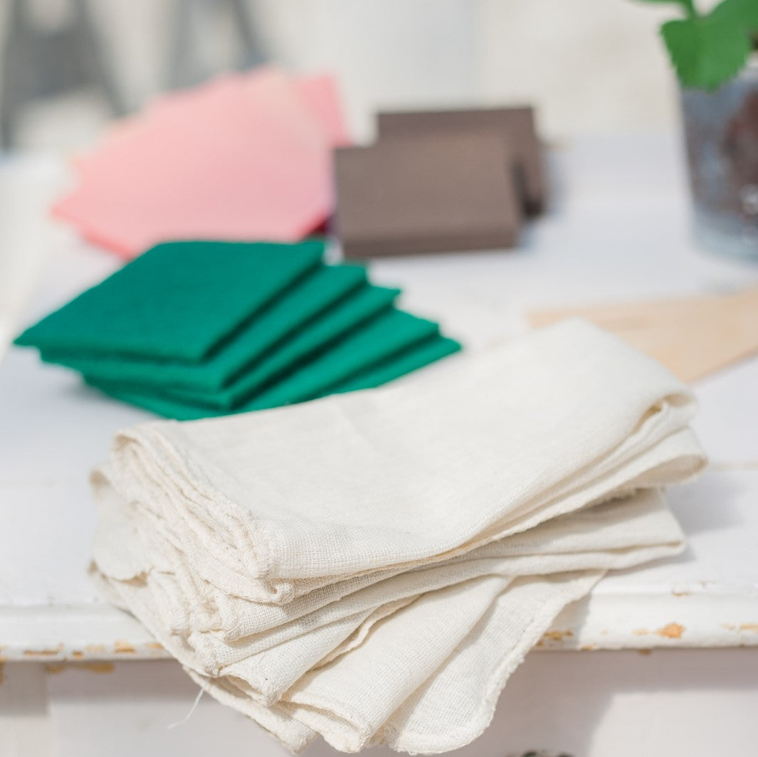 furniture painting supplies and tools - lint-free rags, sanding sponges, sanding blocks, sandpaper, stir sticks, and scouring pads