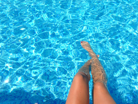 legs floating on pool