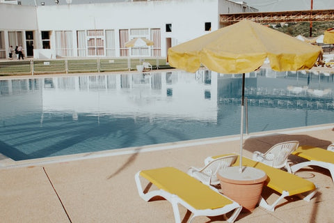 lounge chairs and umbrella near pool