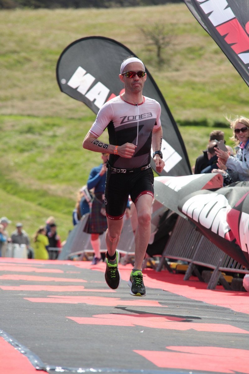 Conal McBride Ironman Triathlete Running Racing Finish Line