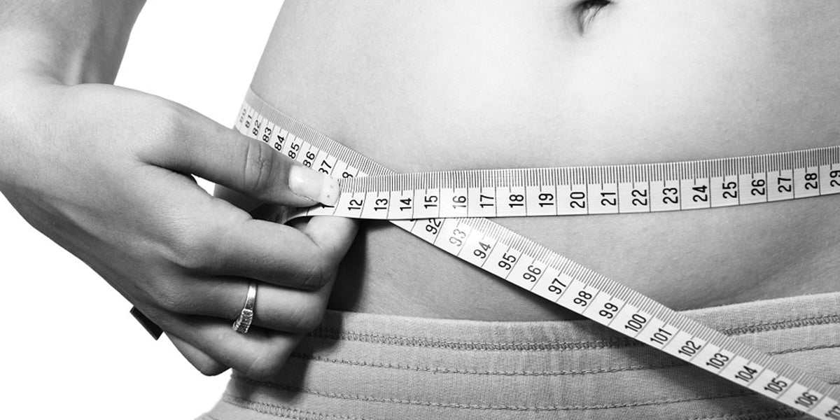 black and white image of measuring tape belly