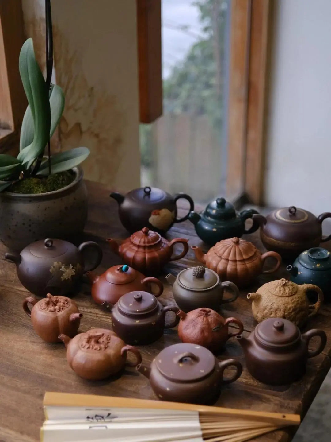 Various classic Yixing teapot shapes and sizes displayed, from small 100ml pots to larger forms, illustrating shape differences.