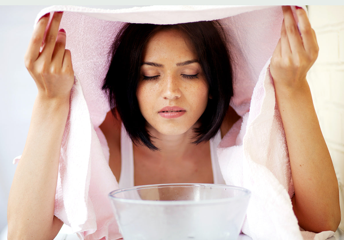 Heat the water in a pot until it begins to steam. Transfer to a bowl and cover your head and bowl as if you were making a tent. Then steam your face for 5 to 10 minutes until it begins perspiring.